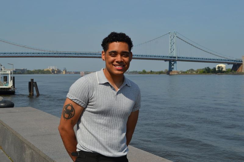 Jabree Flor on the Philadelphia waterfront, the Ben Franklin Bridge behind